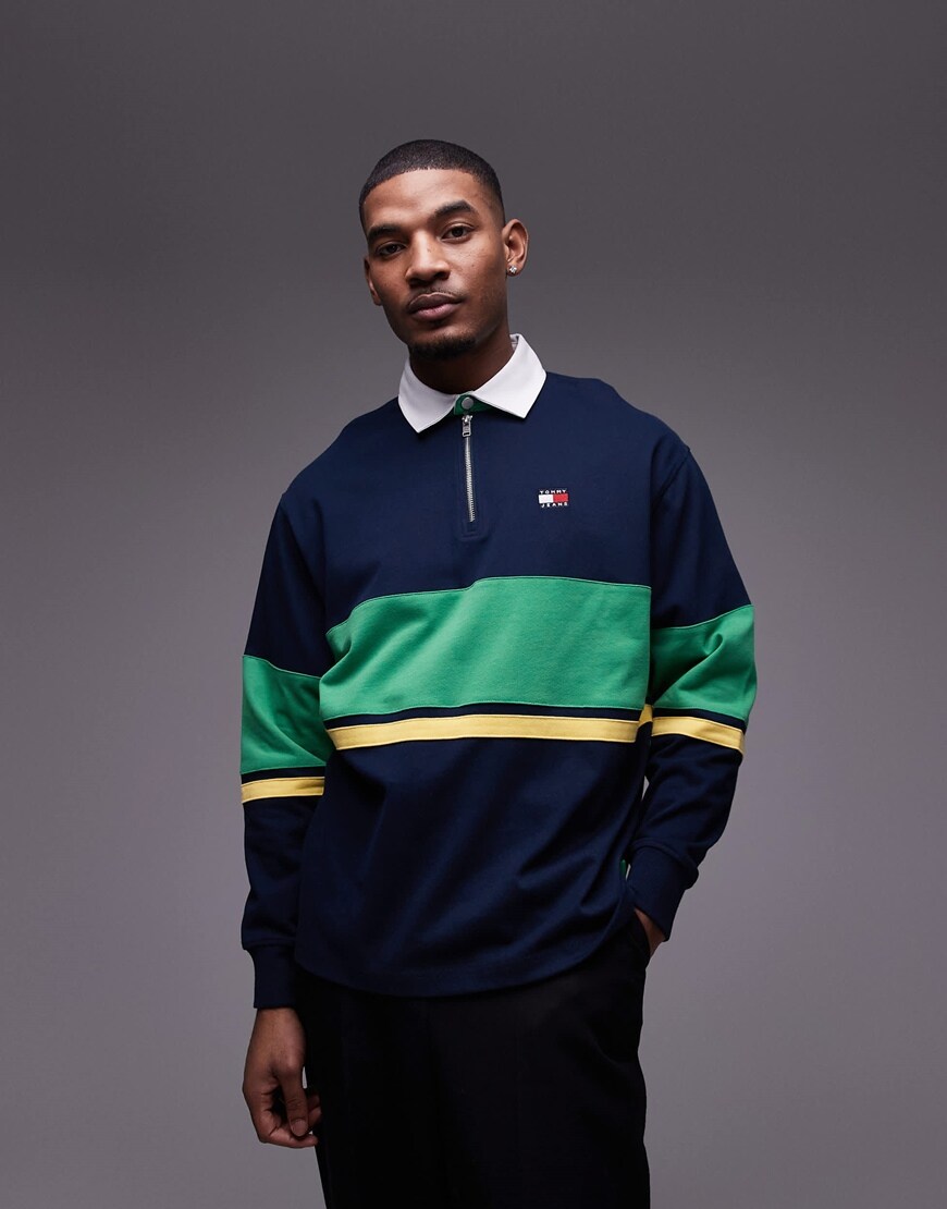 A model wearing a colour block rugby top