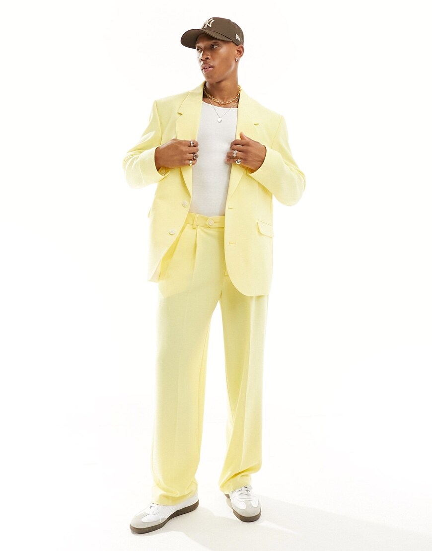 A model wearing a yellow suit jacket