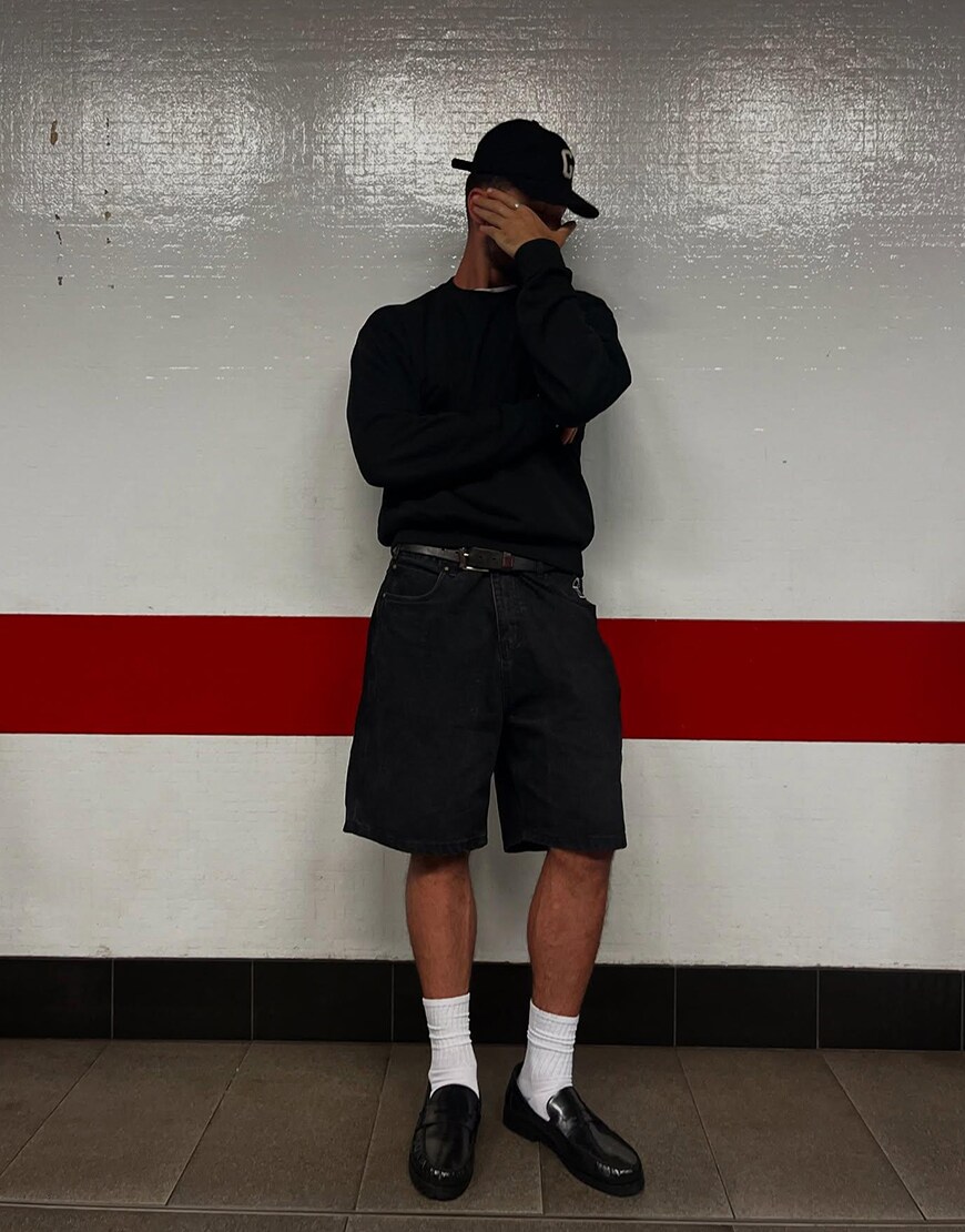 Man Wearing A Sweatshirt And Jorts