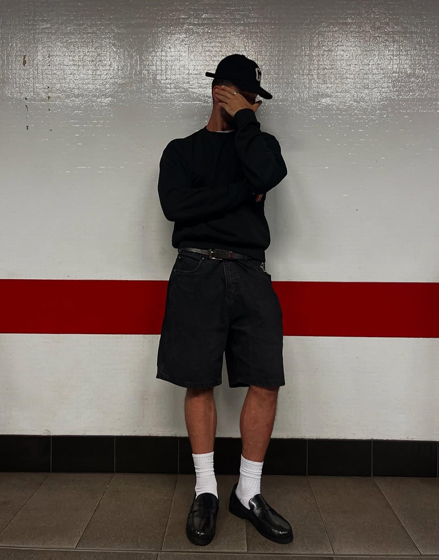 Man Wearing A Sweatshirt And Jorts