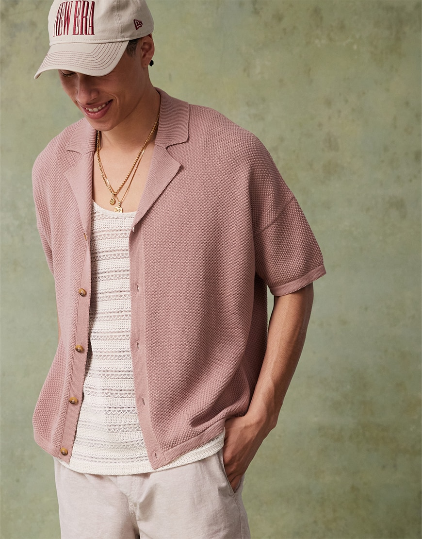 Model wearing a buttoned mauve shirt