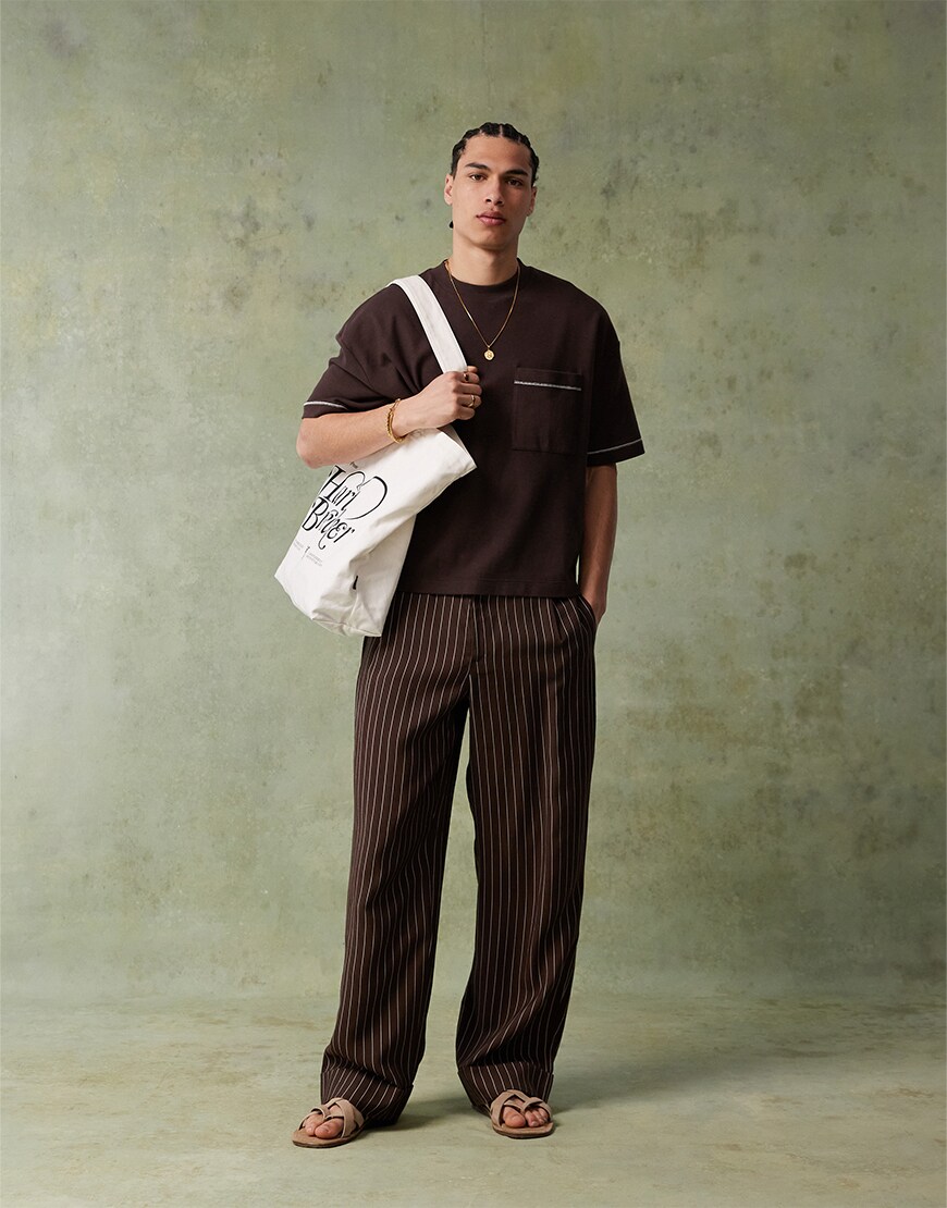 Man wearing a brown t-shirt and trousers