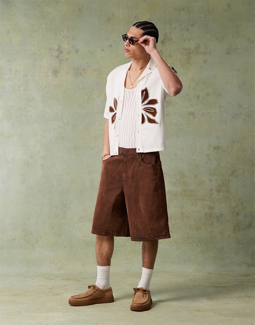 Man wearing white shirt and brown shorts