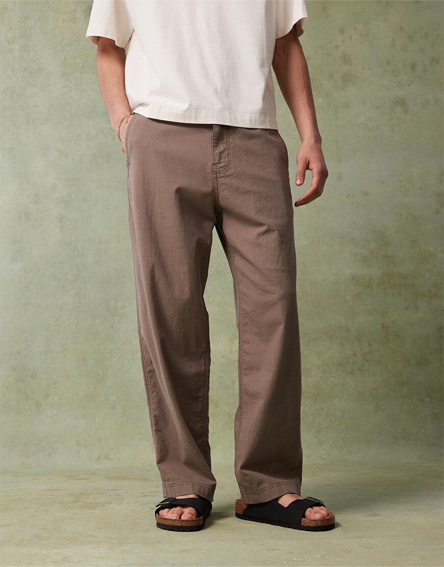 Man wearing brown trousers and Birkenstocks