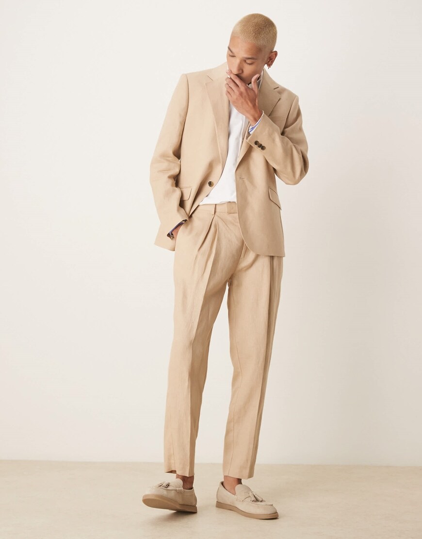 Model wearing a beige slim fit suit