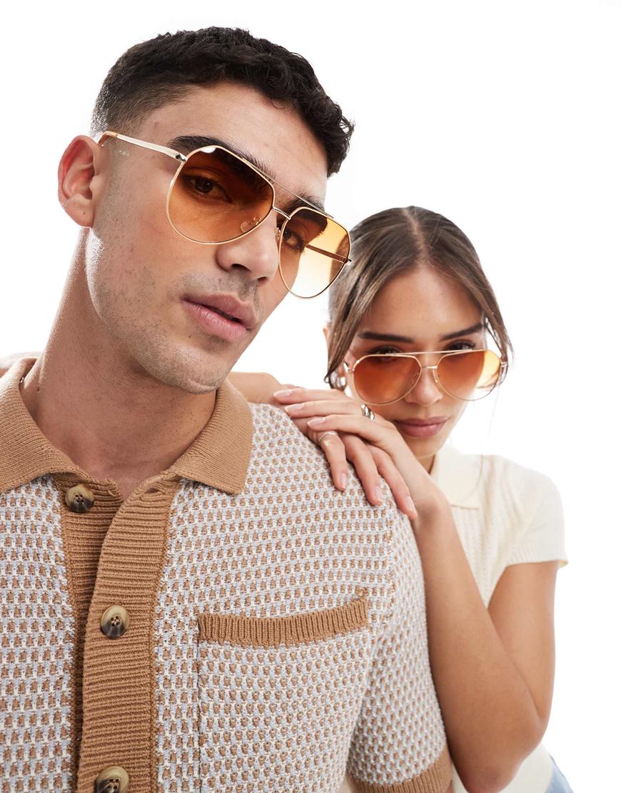 Model wearing gold aviator glasses