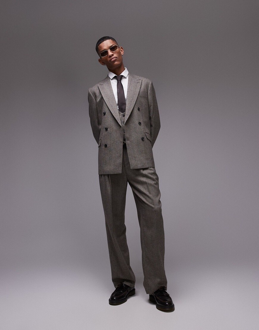Model wearing a grey herringbone suit