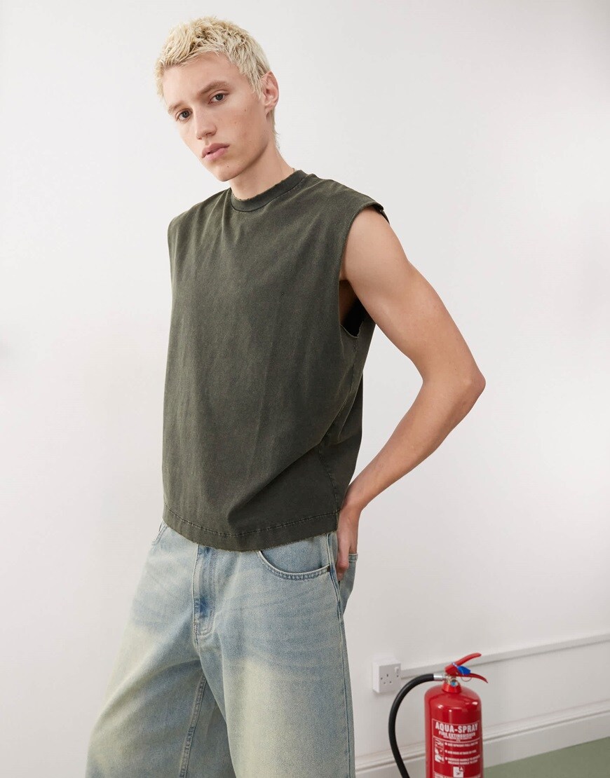 A model wearing a boxy tank in off-black