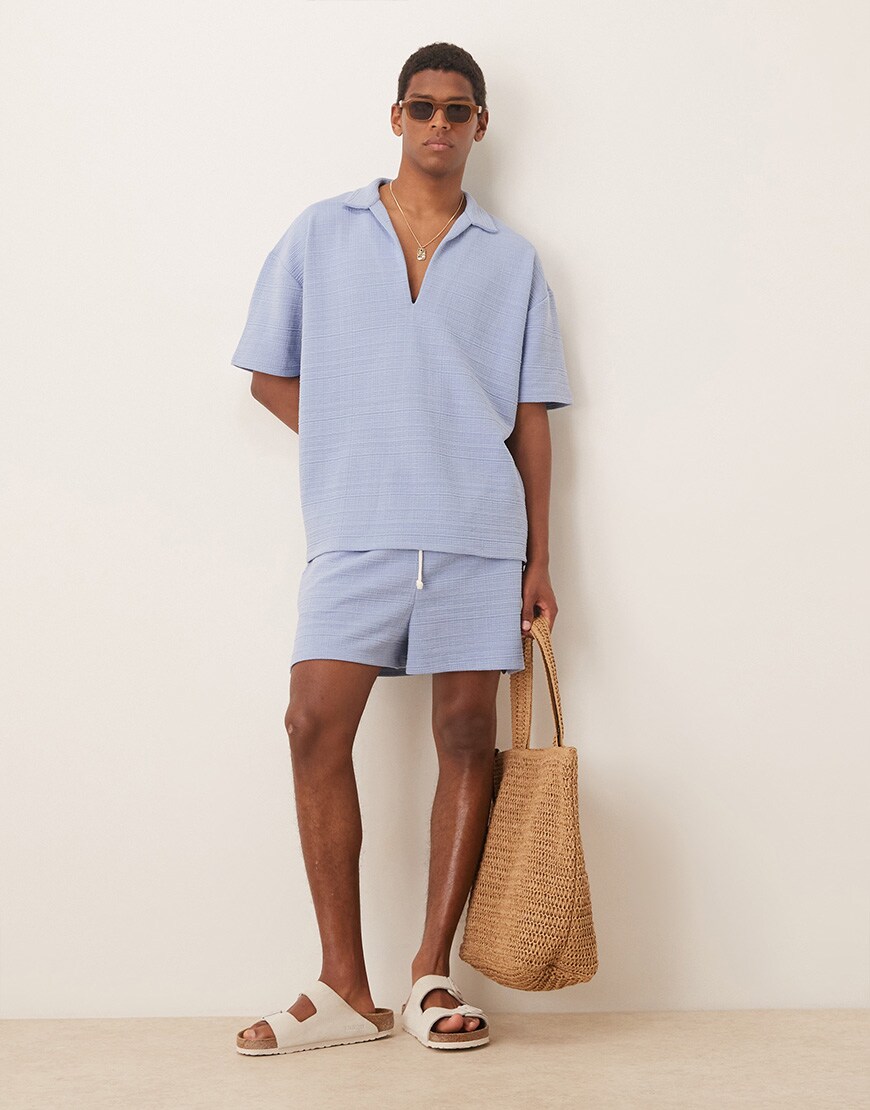 A model wearing a light blue top 