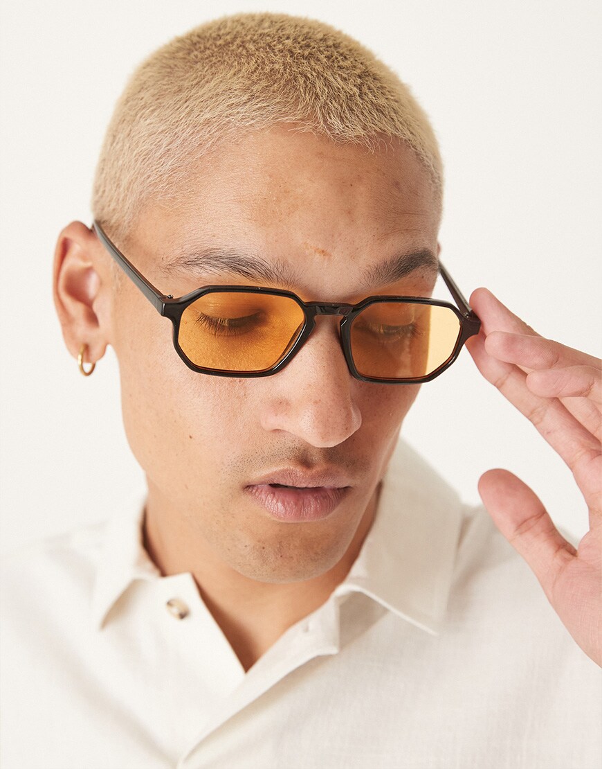 A model wearing glasses with a yellow lens