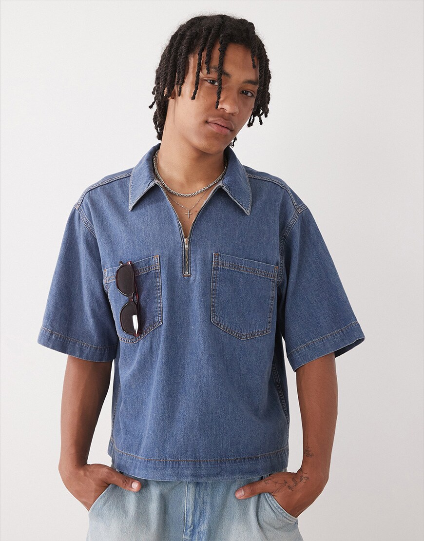 A model wearing a boxy denim shirt