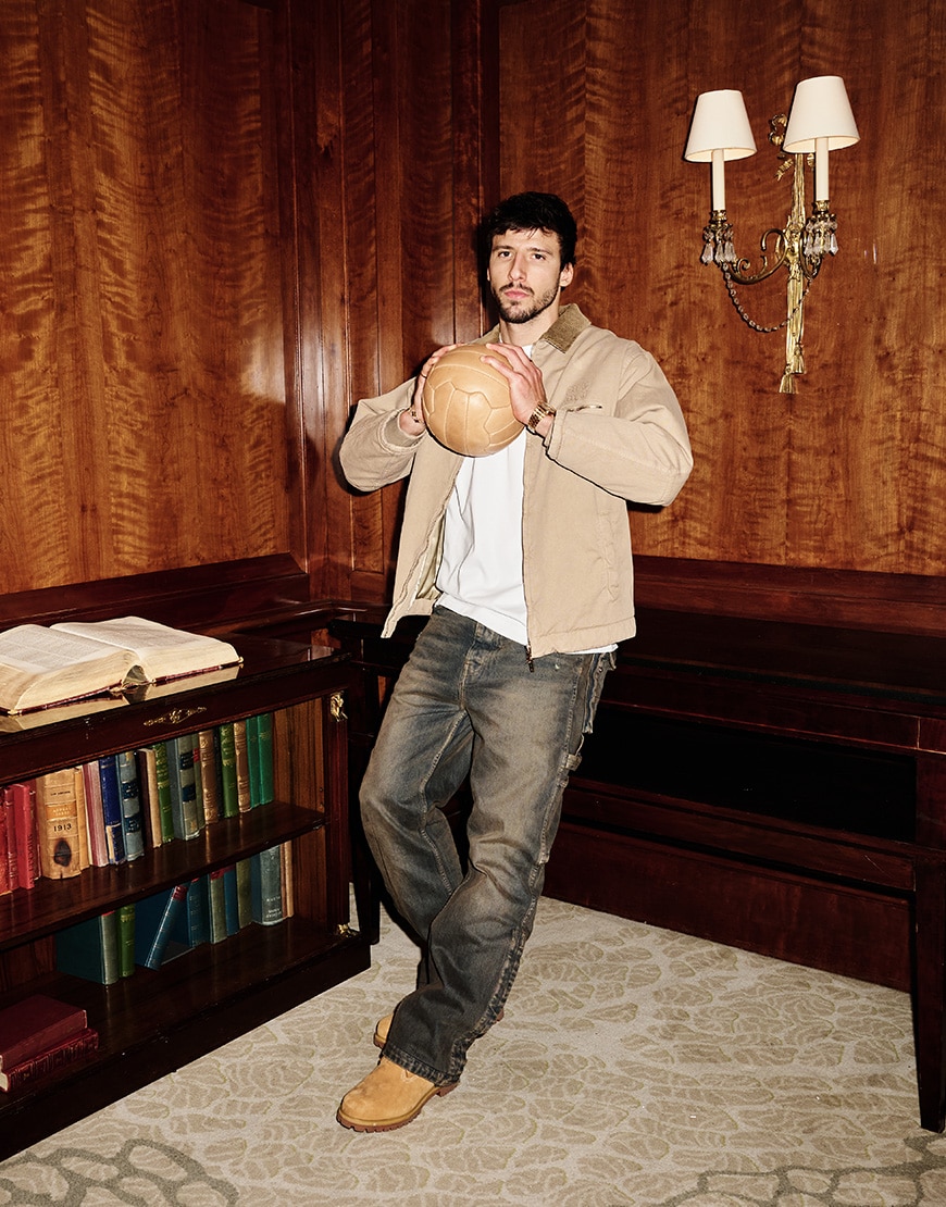 Ruben Dias holding football wearing workwear look
