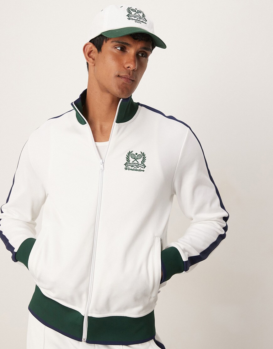 A model wearing a white and green track top