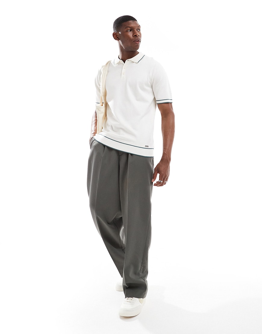 A model wearing a white polo shirt
