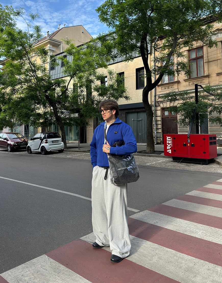 An ASOSer wearing a blue track jacket and tailored trousers