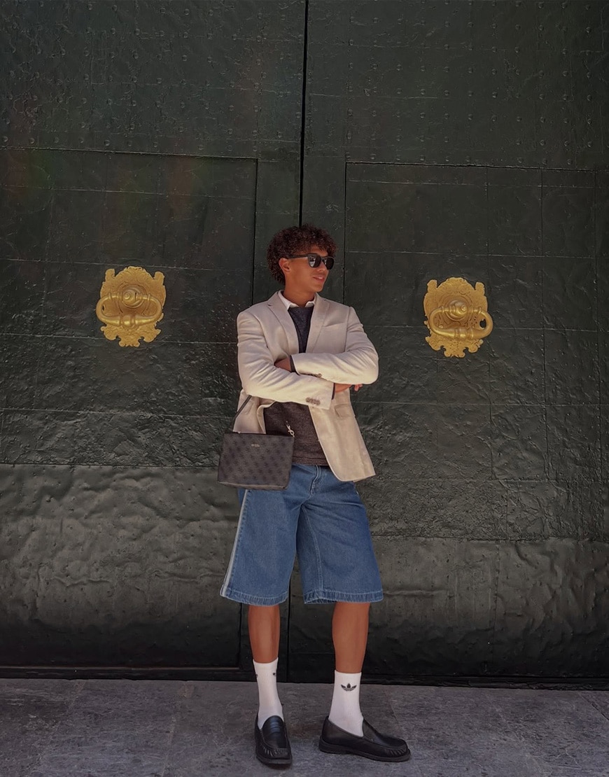 An ASOSer wearing a blazer with adidas jorts