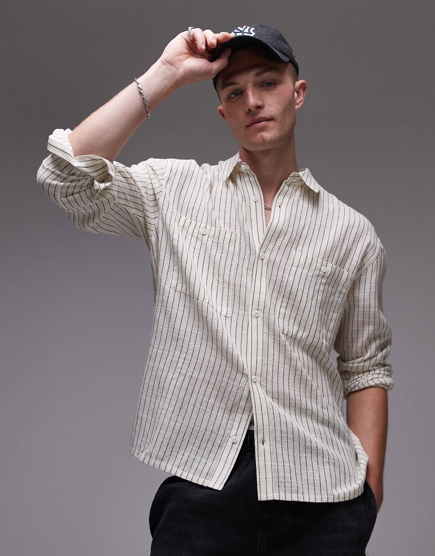 A model wearing a striped cream shirt