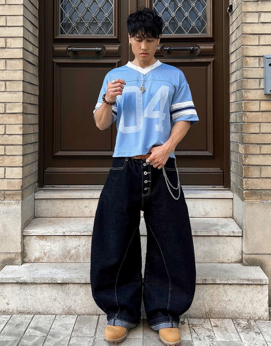 Man wearing blue football jersey and wide-leg jeans | ASOS Style Feed