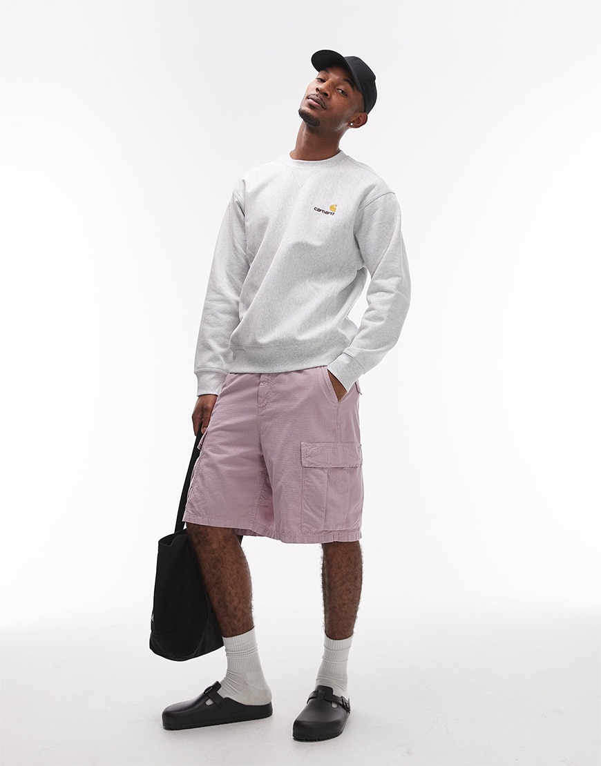 Model wearing bright cargo shorts outfit