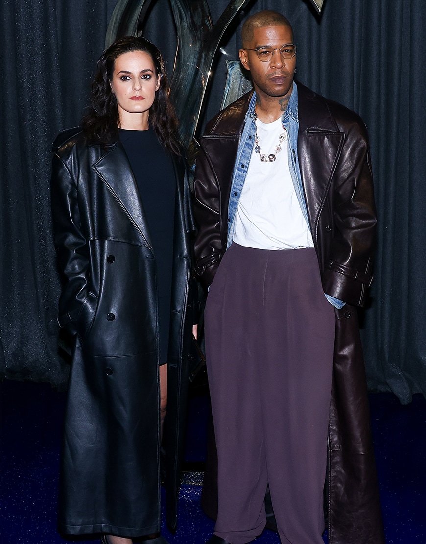 Kid Cudi wearing a black leather jacket with Lola Abecassis Sartore