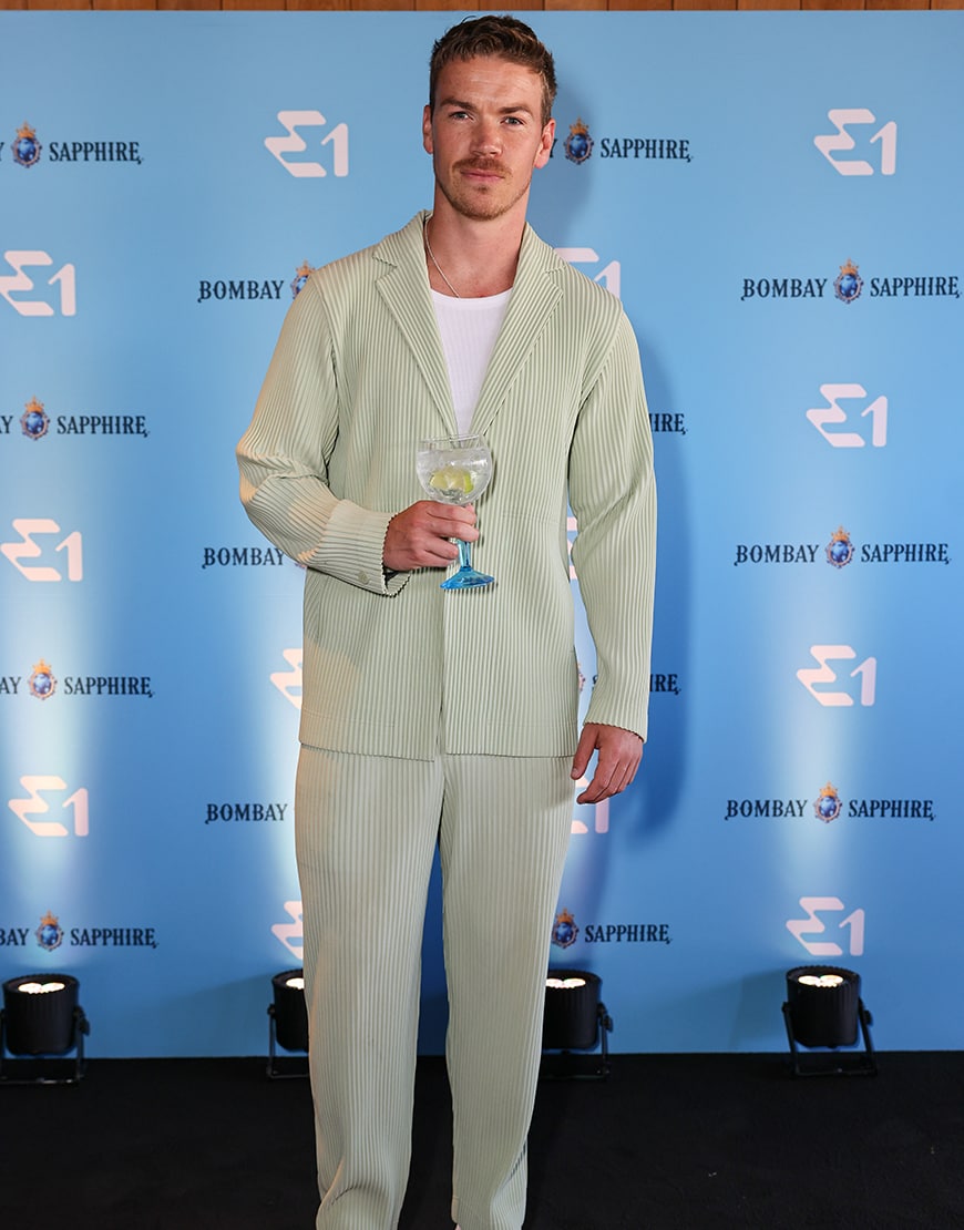 Will Poulter wearing a green striped suit