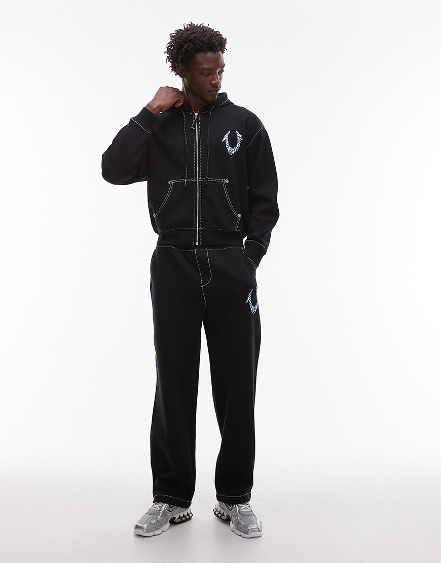 Model wearing a True Religion tracksuit set