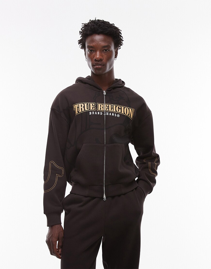 Model wearing a brown True Religion hoodie
