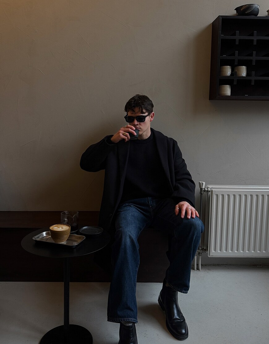 Man wearing dark tailored coat and drinking coffee | ASOS Style Feed