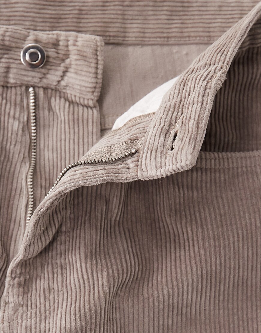 Closeup of zipper of corduroy trousers