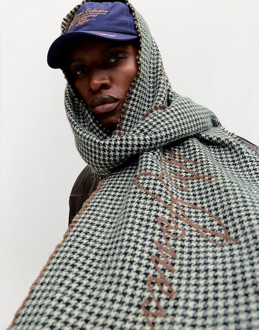 Man wearing a scarf over a hat