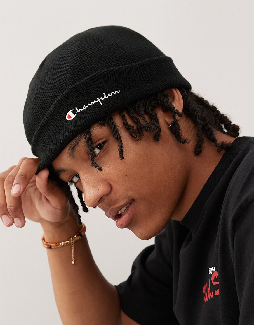 Man wearing a black Champion beanie