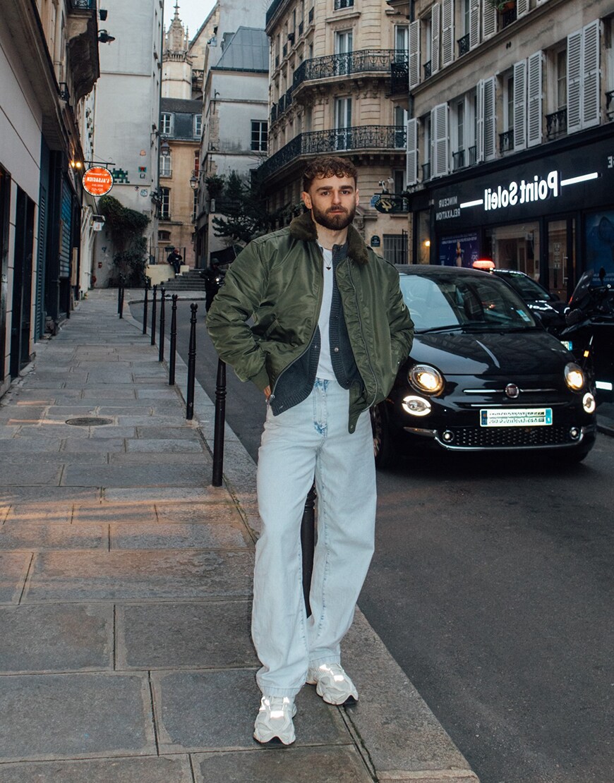Man wearing a khaki bomber jacket