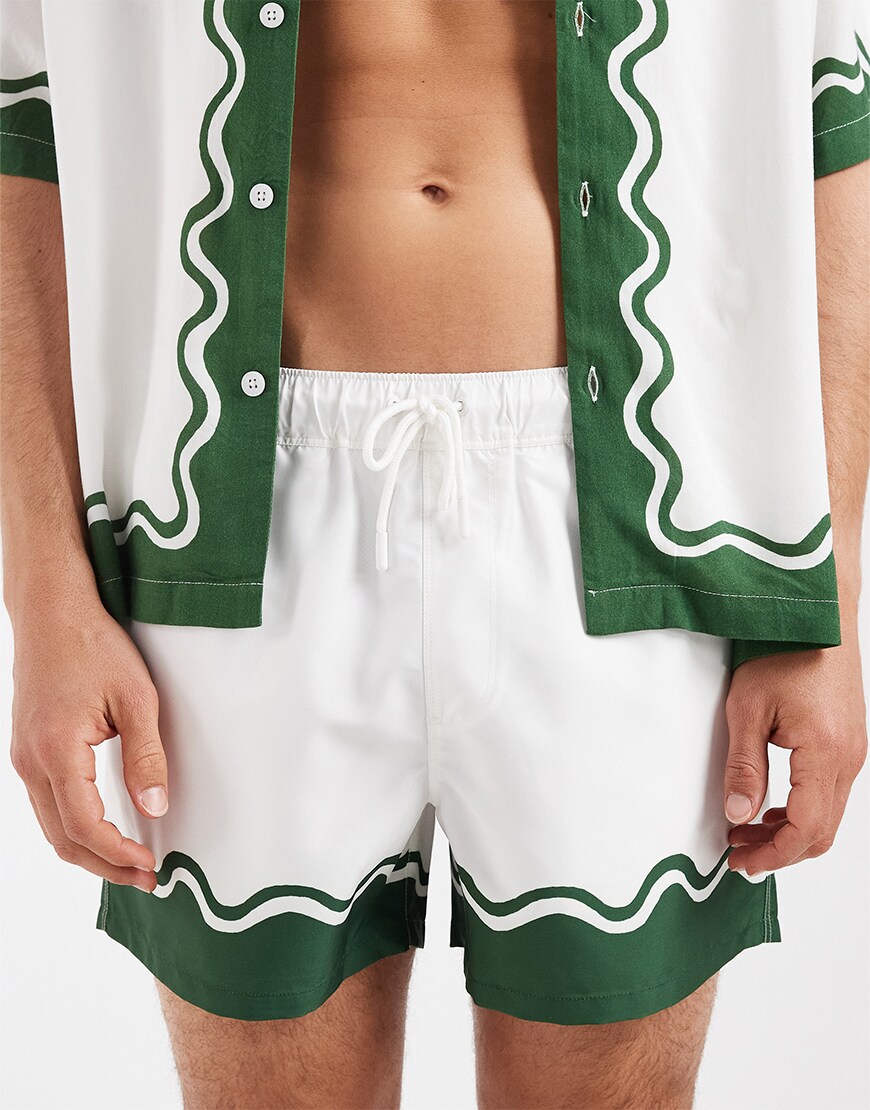 model wearing white swim shorts|ASOS Style Feed