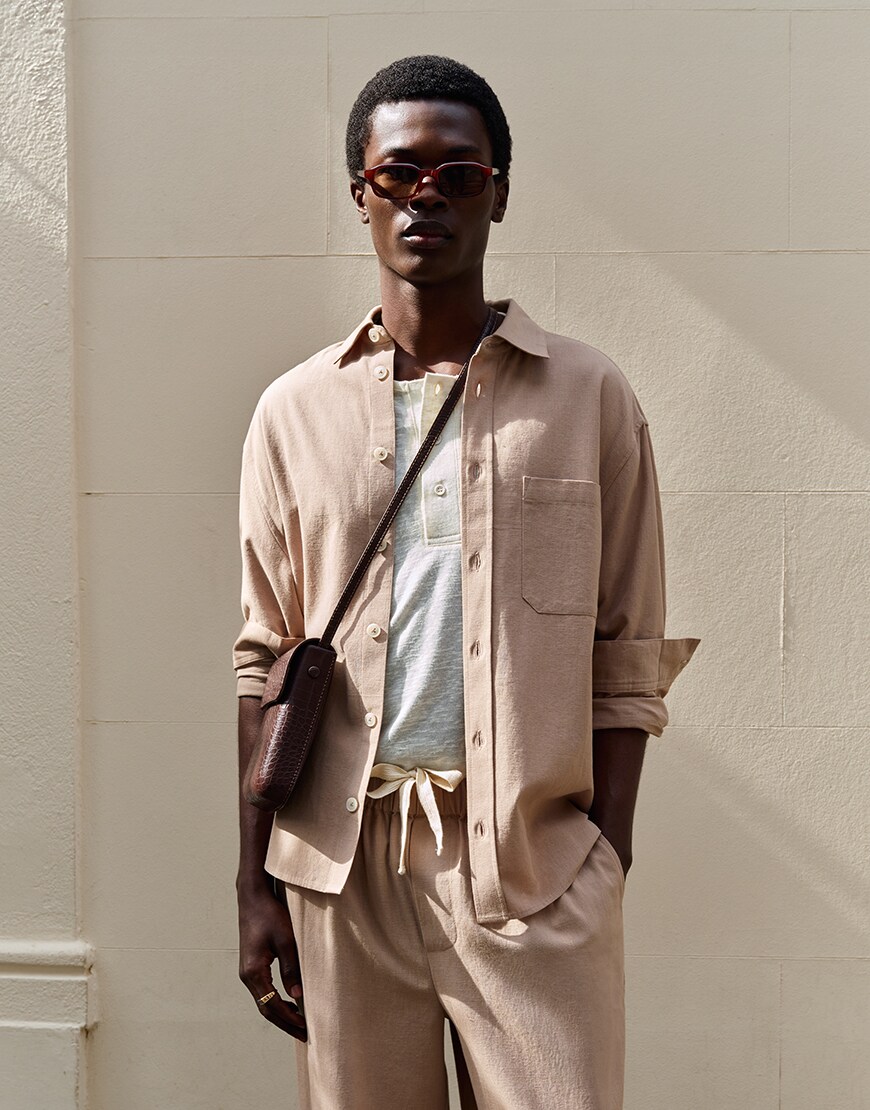 Man wearing beige co-ord and crossbody bag | ASOS Style Feed