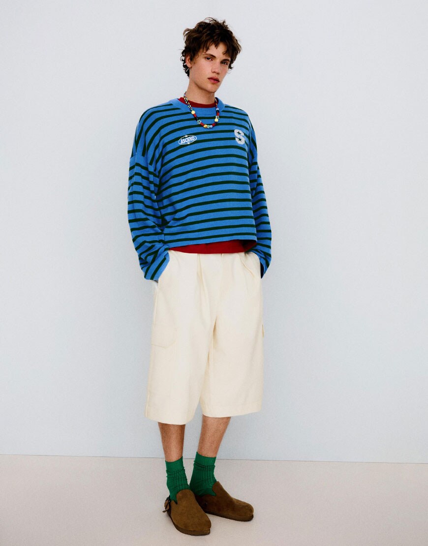 A man wearing longline cargo shorts | ASOS