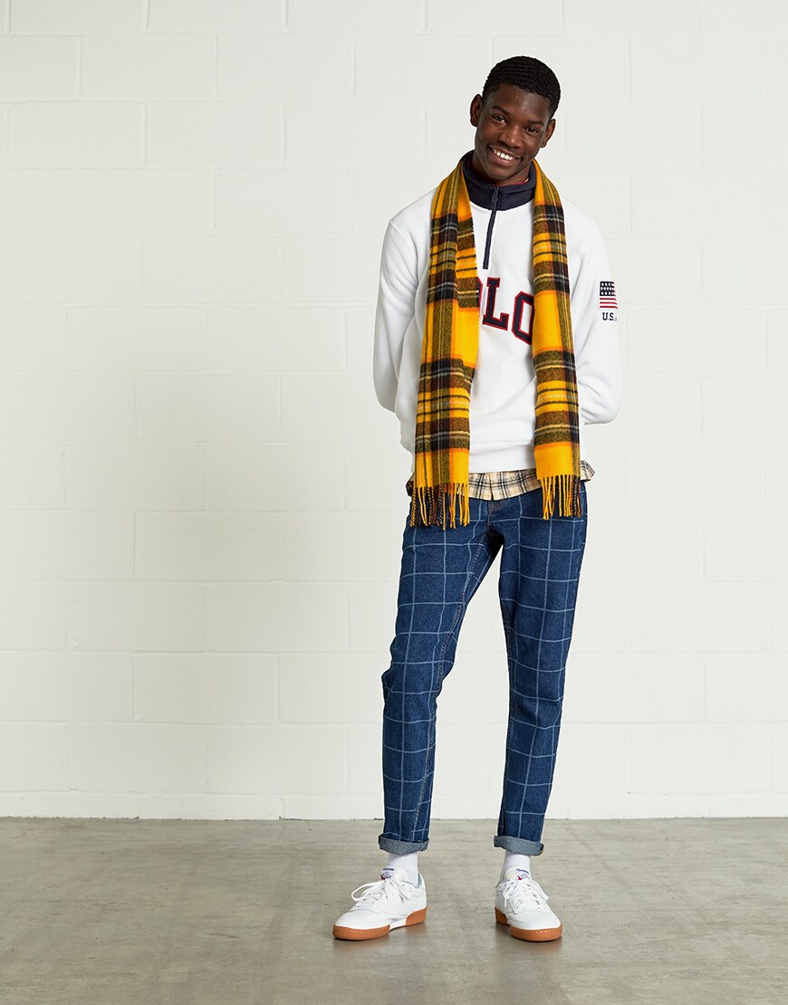 A model wearing a half-zip top, check-print jeans, plaid shirt, tartan scarf and Reebok trainers | ASOS Style Feed