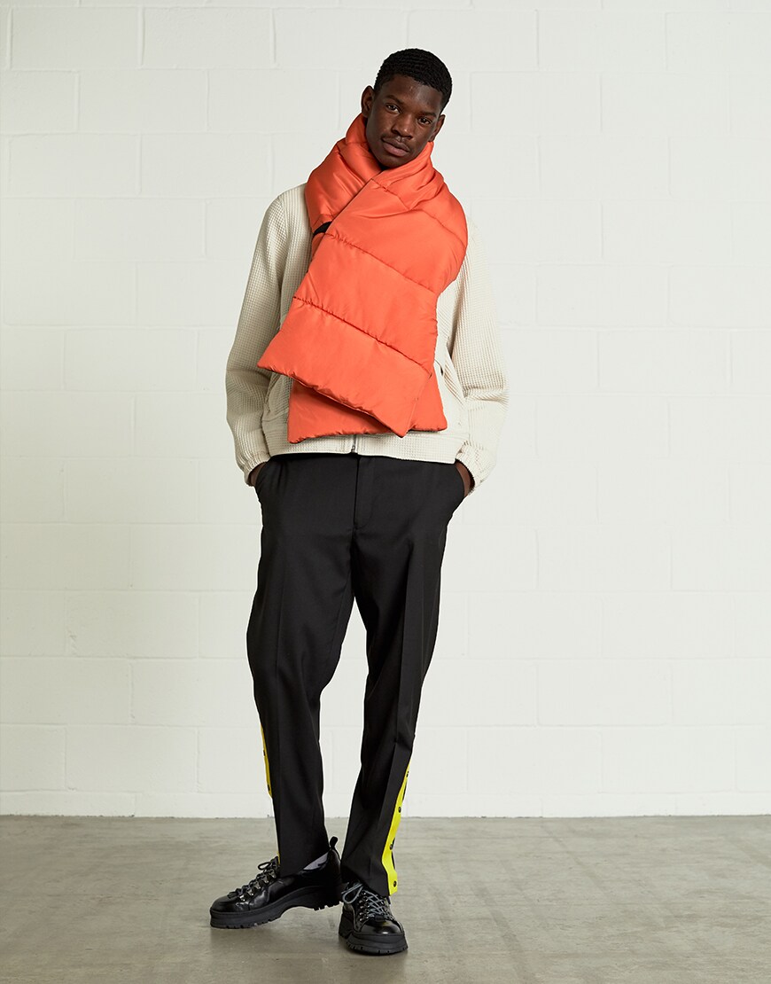 A model wearing a cream zip top, orange scarf, tracksuit bottoms and lace-up boots | ASOS Style Feed