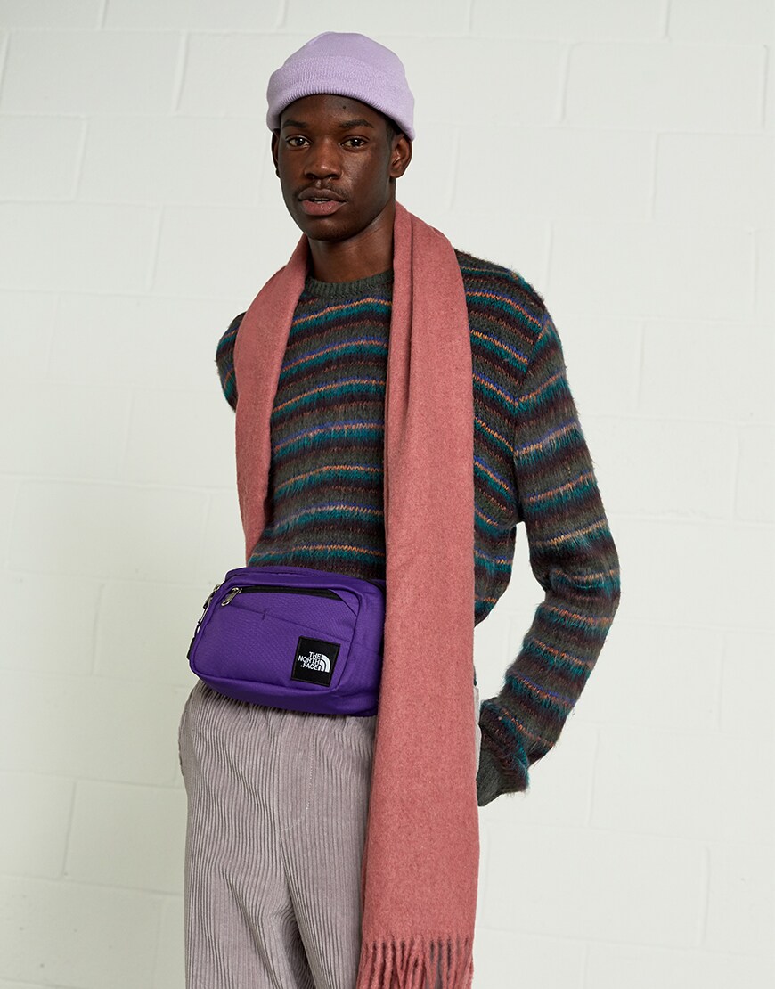 A model wearing a lilac beanie, striped jumper, dusky-pink scarf and bright-purple bumbag | ASOS Style Feed
