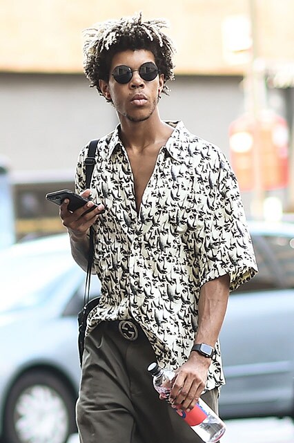 A street-styler wearing a printed revere collar shirt, khaki trousers and white trainers | ASOS Style Feed