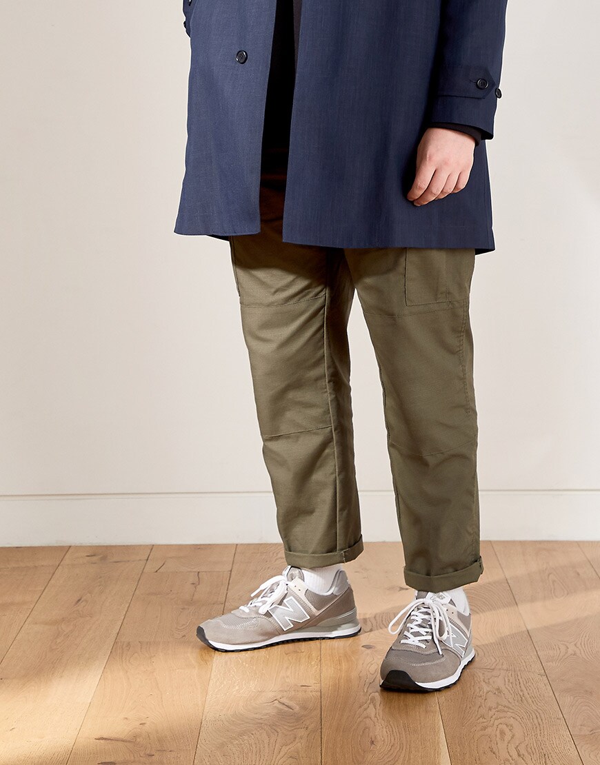 Josh wearing a navy coat, khaki trousers and grey New Balance trainers available at ASOS | ASOS Style Feed