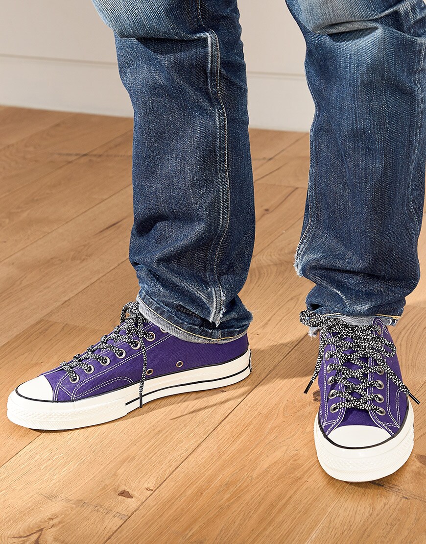 A close-up of Nic's Converse trainers | ASOS Style Feed