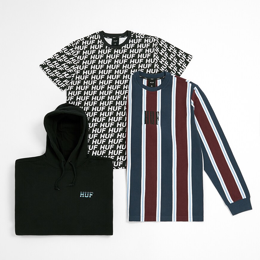 A black logo hoodie, all-over print T-shirt and striped, long sleeve T-shirt from skateboarding brand HUF