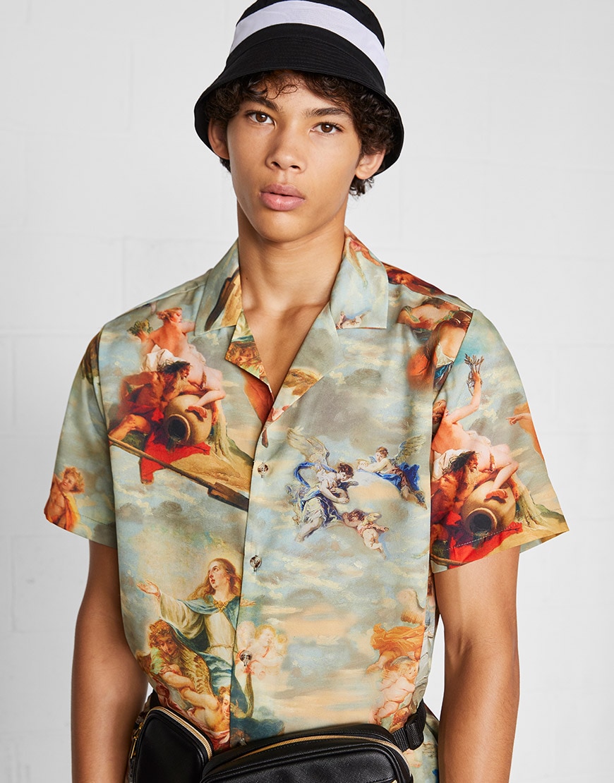 A model wearing a classical painting-print revere-collar shirt, bucket hat and a bum bag | ASOS Style Feed