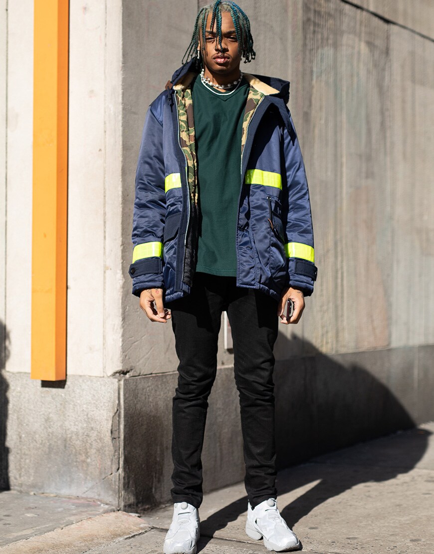 A picture of a street styler wearing a jacket with neon stripes