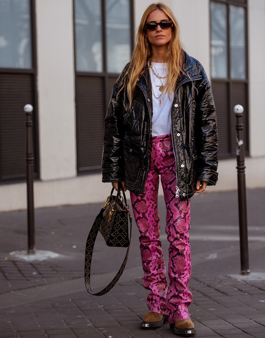 A female street styler wearing neon animal print trousers