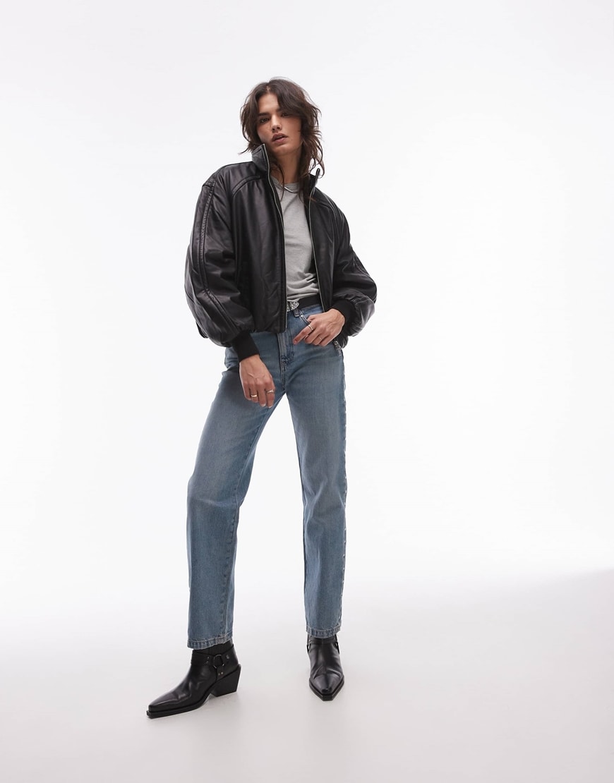 A woman wearing a leather bomber jacket and jeans | ASOS Style Feed
