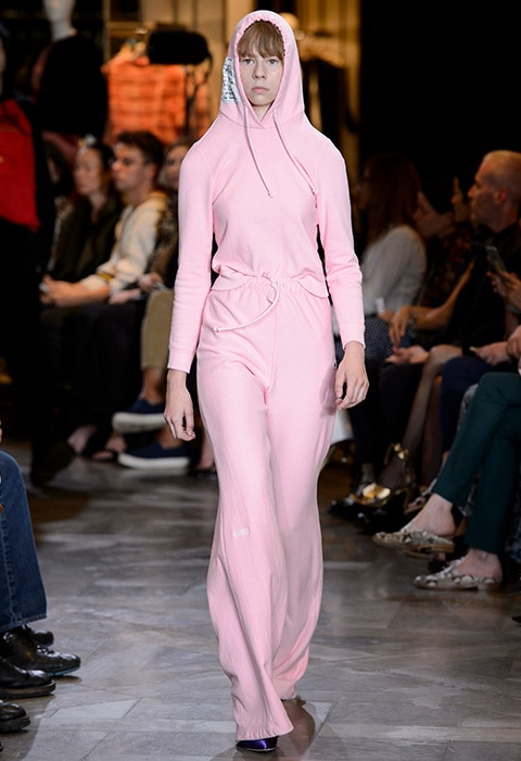 Vetements SS17 catwalk model wearing a pink hoodie, tracksuit bottoms and black heeled boots | ASOS Fashion & Beauty Feed