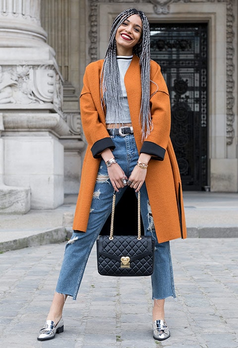 Blogger Syana from Paris wearing an orange duster coat, grey tank top and silver loafers | ASOS Fashion & Beauty Feed