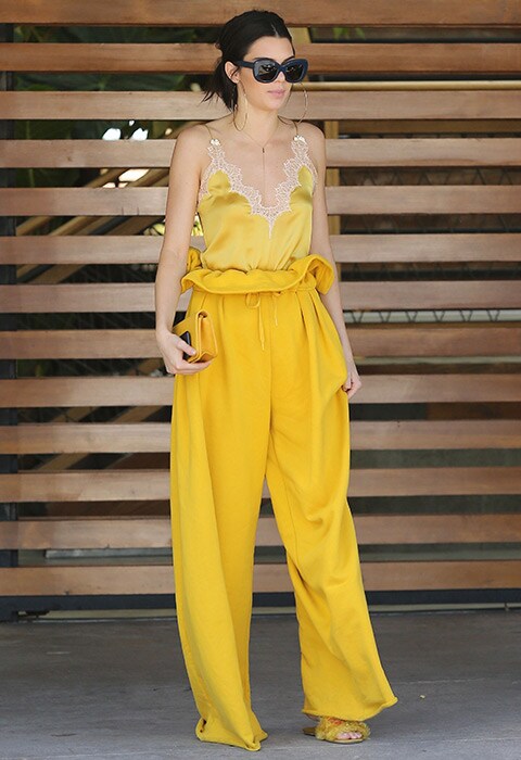 Kendall Jenner wearing a yellow cami top and trousers | ASOS Fashion & Beauty Feed