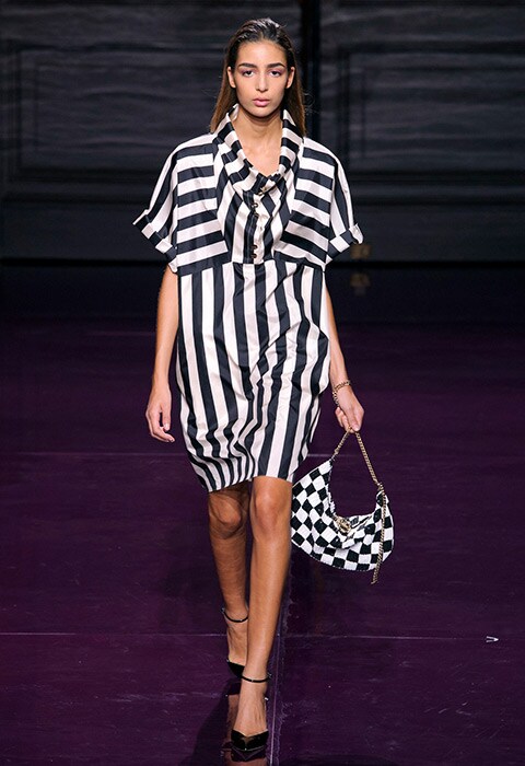 A model wearing a monochrome striped dress with matching bag at the Nina Ricci SS17 show | ASOS Fashion & Beauty Feed